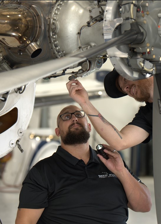 Qmulus technicians inspecting an engine installation