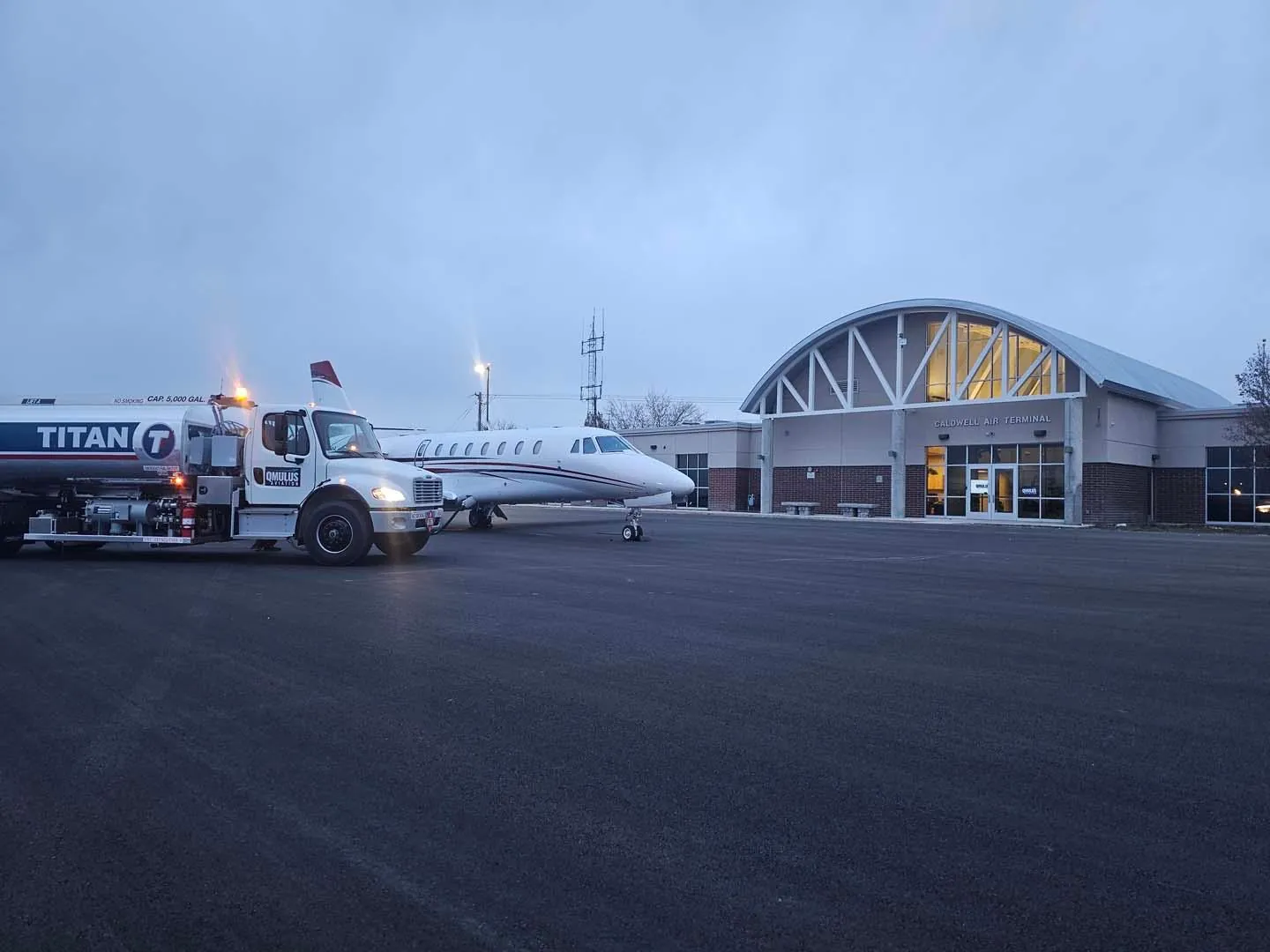 Qmulus Aviation fuel truck beside a business jet at the Caldwell Air Terminal